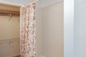 a bathroom with a shower with a shower curtain at Whataday by Pristine Properties Vacation Rentals in Cape San Blas +29 photos