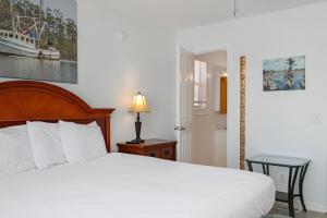 a bedroom with a bed and a table with a lamp at Whataday by Pristine Properties Vacation Rentals in Cape San Blas