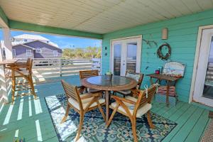 a table and chairs on the porch of a house at Pelican Bend by Pristine Properties Vacation Rentals in Indian Pass
