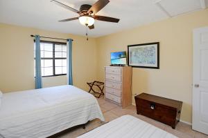 a bedroom with a bed and a ceiling fan at Pelican Bend by Pristine Properties Vacation Rentals in Indian Pass