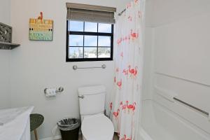 a bathroom with a toilet and a shower curtain at Pelican Bend by Pristine Properties Vacation Rentals in Indian Pass +38 photos