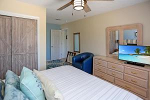 a bedroom with a bed and a flat screen tv at Pelican Bend by Pristine Properties Vacation Rentals in Indian Pass