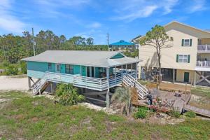 a house on the beach with a house at Pelican Bend by Pristine Properties Vacation Rentals in Indian Pass