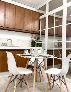 a kitchen with a table and chairs in a room at Balay by JMB in Legazpi