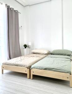 a bed in a white room with a bed frame at Balay by JMB in Legazpi