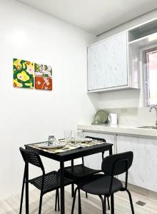 a dining room table with chairs in a kitchen at Balay by JMB in Legazpi +5 photos