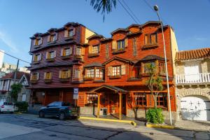 a large wooden building on the corner of a street at Hosteria Sirenuse in Mar del Plata