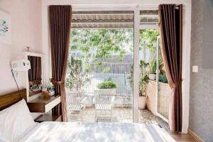 a bedroom with a bed and a sliding glass door at MyHouse in Da Lat +38 photos