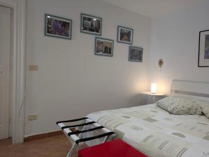 a bedroom with a bed and pictures on the wall at Casa RoSiLù in Monopoli