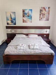 a bed in a room with two towels on it at Pavle Petra apartments in Mitrovići