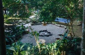 a garden with a park bench in the background at Hogar na mata in Ubatuba +22 photos