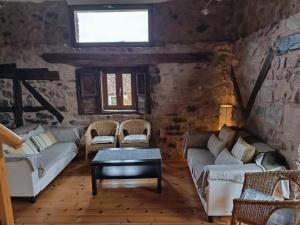 a living room with two couches and a window at Casa Fabiana in Montenegro de Cameros