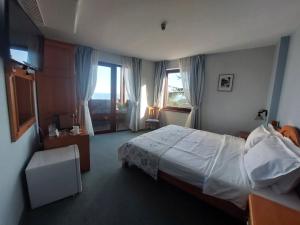 a hotel room with a bed and a window at Family Hotel St Stefan Nessebar in Nesebar