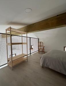 a bedroom with a loft bed and a chair at Apartma OLJKA in Črniče