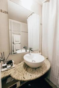 a bathroom with a sink and a mirror at MARON ΙΙ με τζάκι in Kalavrita +42 photos