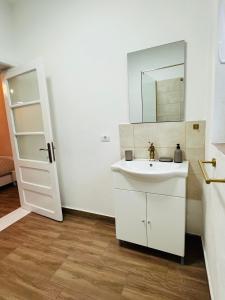 a white bathroom with a sink and a mirror at Casa Andra in Drobeta-Turnu Severin +23 photos