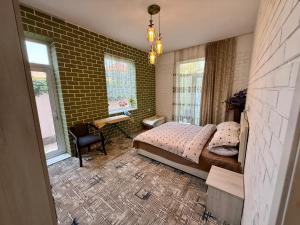 a bedroom with a bed and a desk and windows at Duplex80A in Tashkent +117 photos