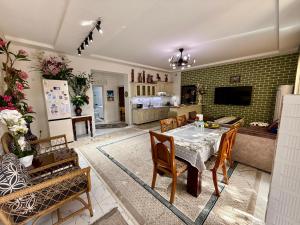 a kitchen and living room with a table and chairs at Duplex80A in Tashkent