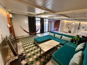 a living room with a blue couch and a table at Duplex80A in Tashkent