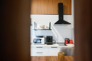 a kitchen with a microwave and a stove top oven at Shkoder City Center Rooms & Apartments in Shkodër