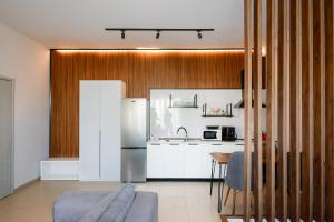a kitchen with a stainless steel refrigerator and a table at Shkoder City Center Rooms & Apartments in Shkodër +23 photos