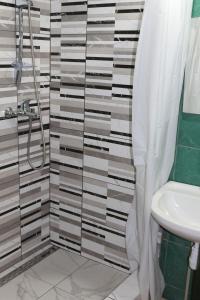 a bathroom with a shower and a toilet and a sink at FKoka in Berehove +36 photos