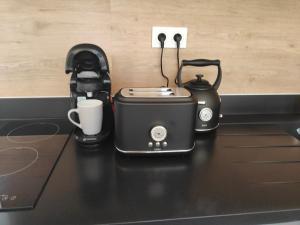 a toaster and coffee maker sitting on a counter at L'Escale in Penvénan