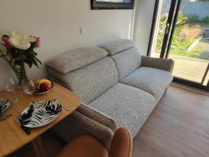 a living room with a couch and a table at L'Escale in Penvénan