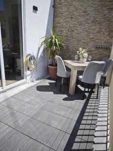 a patio with a table and chairs on a balcony at 119 Bliss Apartment in Sliema