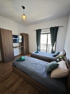 two beds in a room with a window at 119 Bliss Apartment in Sliema