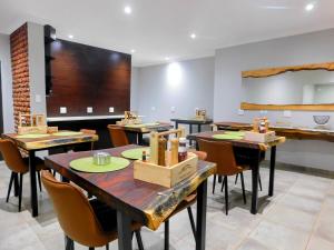 a restaurant with tables and chairs in a room at Mountain Manor in Louis Trichardt