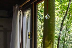 a window with a drop of water hanging from it at Hogar na mata in Ubatuba