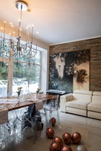 a dining room with a table and a couch at Маєток Ліс і Гори in Bukovel +99 photos