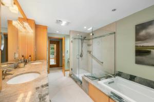 a bathroom with a tub and a shower and a sink at Bufflehead Hideaway in Kennebunk +54 photos