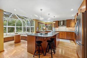 a kitchen with a large island with bar stools at Bufflehead Hideaway in Kennebunk
