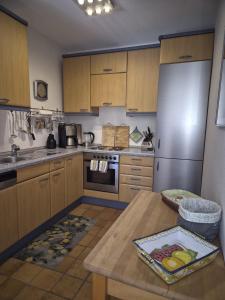a kitchen with a table and a refrigerator at Fewo Amber in Heimbach +17 photos