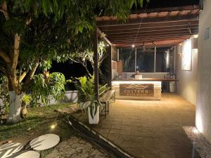 a patio with a bench and a table in a building at Costeño River Minca in Minca
