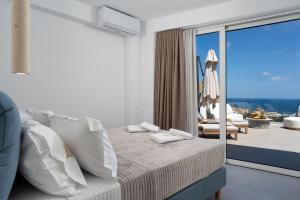 a bedroom with a bed and a balcony with a view at villa yasmin luxury in Bali