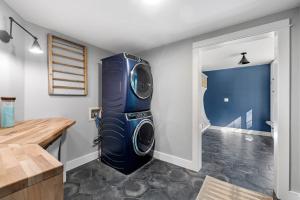 a laundry room with a washer and dryer in it at KPT Salt Pine House Apartment in Kennebunkport +104 photos