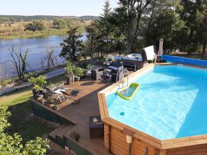 a large swimming pool with a deck and a swimming pool at Gite Spa Zen 2 in Blois