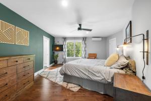 a bedroom with a bed and a dresser and a window at KPT Salt Pine House Apartment in Kennebunkport