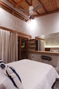 a bedroom with a white bed in a room at Tigbaw in Mactan