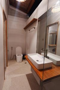 a bathroom with a sink and a tub and a toilet at Tigbaw in Mactan