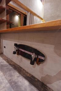 a skateboard is hanging on a wall at Tigbaw in Mactan