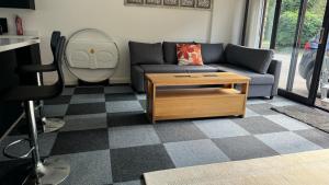 a living room with a couch and a table at Four Poster Hideaway in Chacombe
