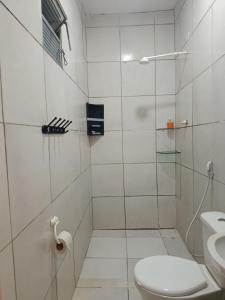 a bathroom with a toilet and a glass shower at Casa de clecia in Natal +15 photos