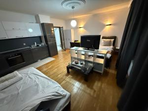 a room with a bed and a desk with a tv at Boutique Apartments Daniela in Ohrid