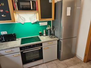 a kitchen with a stove and a refrigerator at Perdöhl-Wittenburg in Wittenburg +8 photos