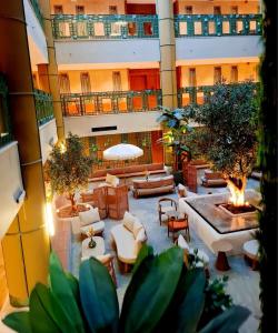 a large building with a courtyard with furniture and a fountain at ثريو thrio للشقق المخدومة in Riyadh