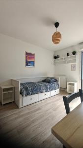 a bedroom with a bed in the middle of a room at CHROMA - Studio Nantes GARE SUD in Nantes
